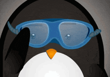 a penguin wearing a pair of blue goggles with a yellow beak