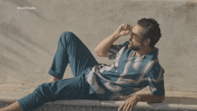 a man is laying on the edge of a pool with the words brazilponcho behind him