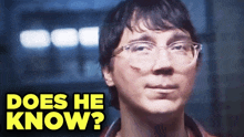 a close up of a man with glasses and the words does he know