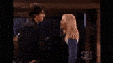 a man and a woman are kissing each other in a room .