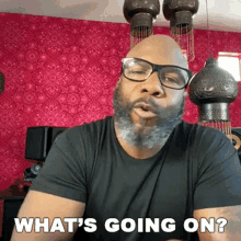 a bald man with glasses and a beard is asking what 's going on