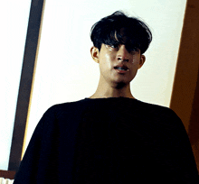a man in a black shirt has a tear running down his face