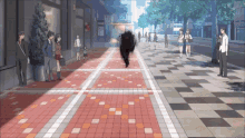 a group of people walking down a brick sidewalk with a sign that says ' a ' on it