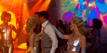 a man and a woman are dancing in a disco