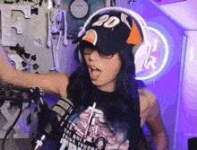 a woman wearing headphones and a hat that says 20 on it