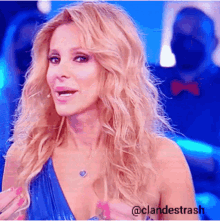 a woman with blonde hair is wearing a blue dress and a necklace