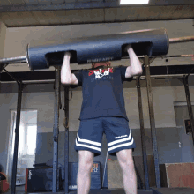 a man lifting a barbell with a shirt that says mirafit on it