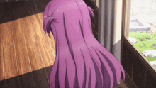 a girl with purple hair looks out a window