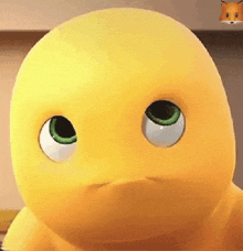 a close up of a yellow cartoon character with green eyes looking at the camera .