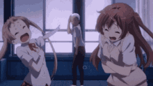 a man and two girls are standing in front of a window and one girl is crying