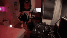 a man kneeling in front of a dj mixer with a sign that says love twisted on it