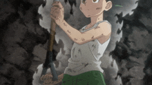 a boy in a white tank top is holding a wooden stick in his right hand and the bottom of the screen says finally.com