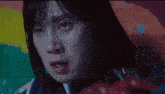 a close up of a woman 's face with her mouth open