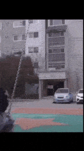 a white car is parked in front of a building with a sign that says ' a ' on it