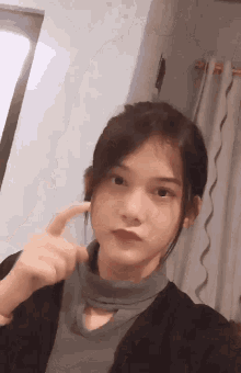 a young girl is taking a selfie with her finger