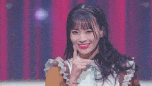 a girl holds a microphone in her hand and points to the side