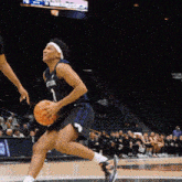 a female basketball player wearing a number 1 jersey is running with the ball