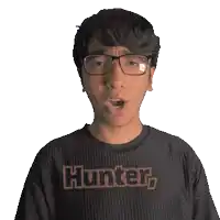 a man wearing glasses and a black shirt that says hunter on it
