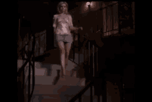 a woman is standing on a set of stairs and taking off her top .