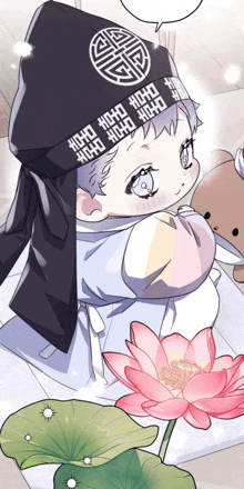 a baby wearing a hat with chinese writing on it