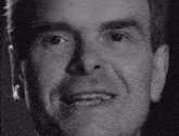 a close up of a man 's face with a smile on it