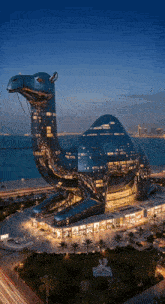 a large building in the shape of a camel with a sign that says dubai