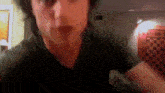 a blurry picture of a man 's face with a checkered wall in the background