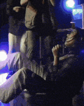 a man is singing into a microphone while laying on the floor .