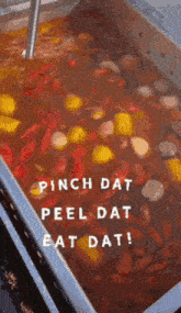 a large pot of food with the words pinch dat peel dat eat dat written on it