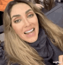 a close up of a woman 's face with her mouth open .