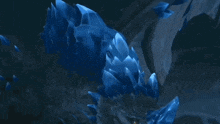 a blue dragon with a yellow eye is laying on the ground
