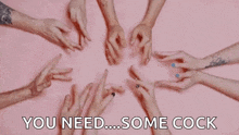 a group of people 's hands are making a heart shape on a pink surface .