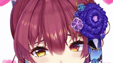 a close up of a girl 's face with a blue flower in her hair