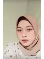 a woman wearing a polka dot shirt and a hijab