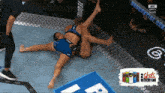 two women are wrestling in a ring with a sign that says 2 shots in every can on the bottom