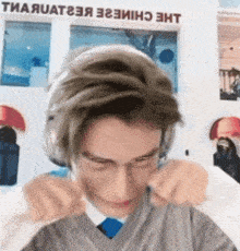 a man wearing headphones and glasses is making a funny face