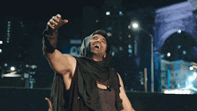 a man with his arms outstretched is wearing a black hood