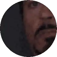 a pixelated image of a man 's face with a beard in a circle