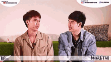 two young men are sitting next to each other with a banner that says max & tui on it