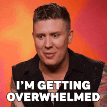 a man with a tattoo on his arm is saying i 'm getting overwhelmed