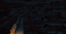 an aerial view of a city at night with a few lights on