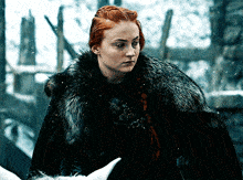 a woman with red hair wearing a black fur coat