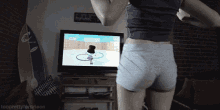 a woman in shorts is playing a video game with the words tooprettyforprison below her