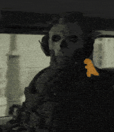 a skeleton wearing headphones is sitting in a dark room