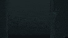 a man in a bullet proof vest stands in a dark room