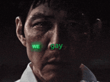 a close up of a man with the words we are gay horses on his face