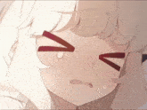 a close up of a girl 's face with a tear coming out of her mouth