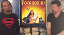 two men are standing in front of a poster for pocahontas