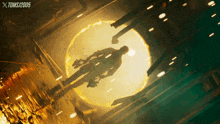 a man is flying through a circle of fire with toms / 2005 written on the bottom