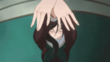 a girl with long hair and glasses is being held upside down by someone 's hands